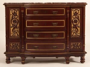 A mahogany chest of drawers, from circa 1880, with carved and inlaid decoration and the original marble top